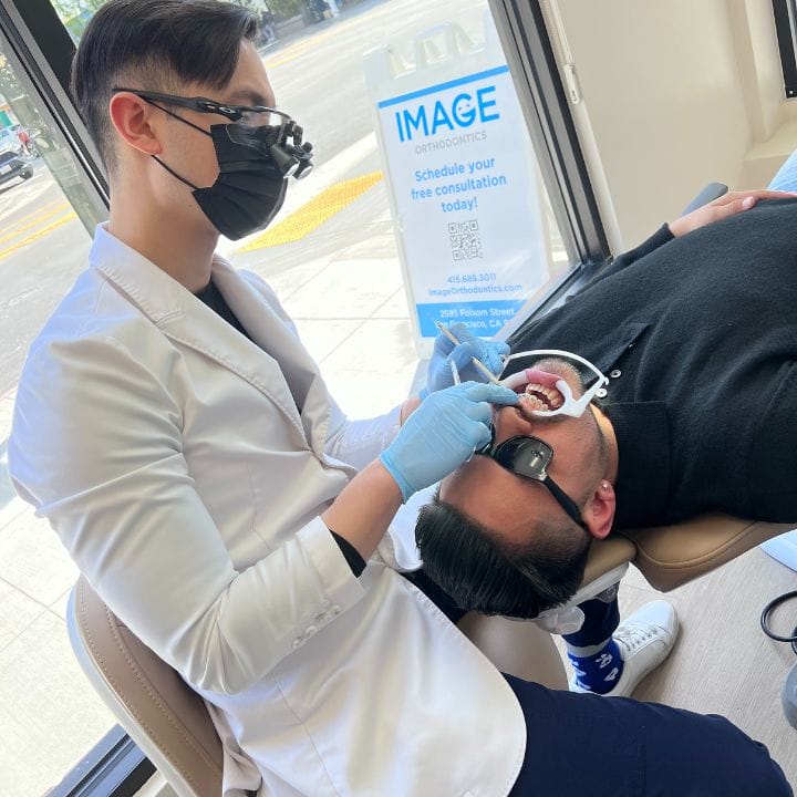 Dr Wilson doing a dental check up to a patient at Image Orthodontics Mission District