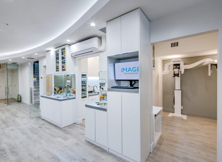 Sleek reception and treatment prep area in the Pacific Heights clinic with white built-in cabinet.