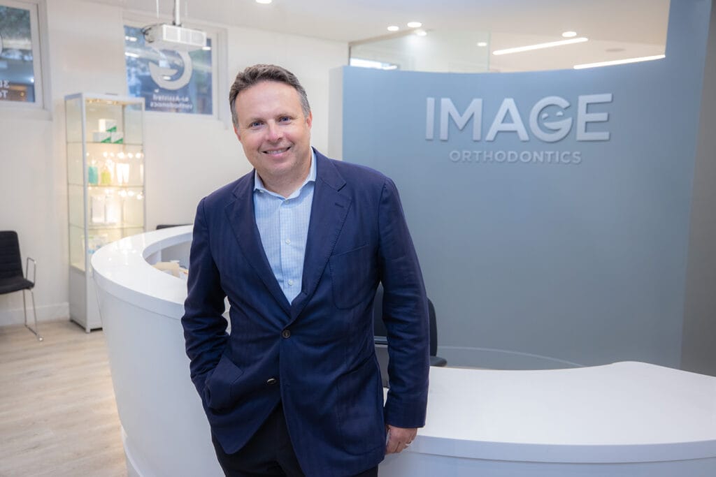 Dr. Yan Kalika at the front desk of Image Orthodontics' Pacific Heights clinic.