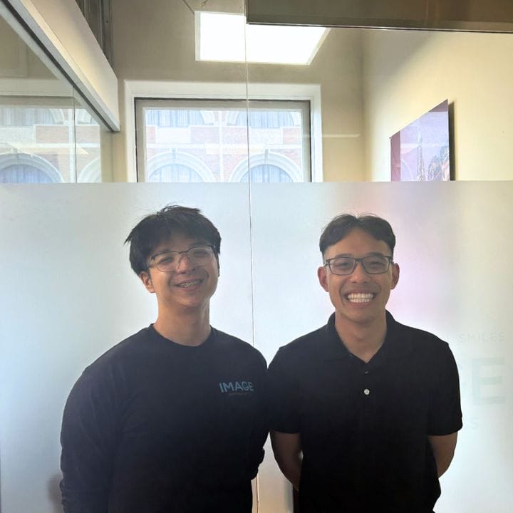A dental patient at Post Street alongside an Image Orthodontics Staff member, both smiling.