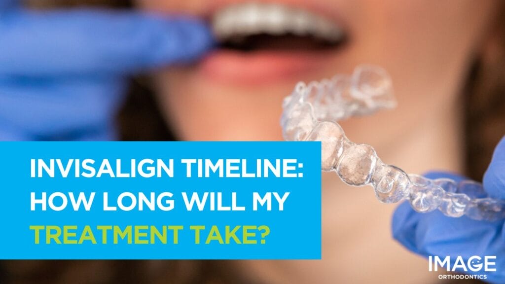 A dental professional wearing blue gloves holds a clear aligner while a patient opens their mouth during an orthodontic consultation
