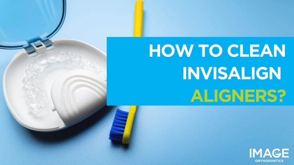 Clear Invisalign aligners in an open case next to a toothbrush