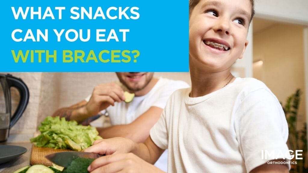 A smiling child wearing braces stands in a kitchen preparing vegetables
