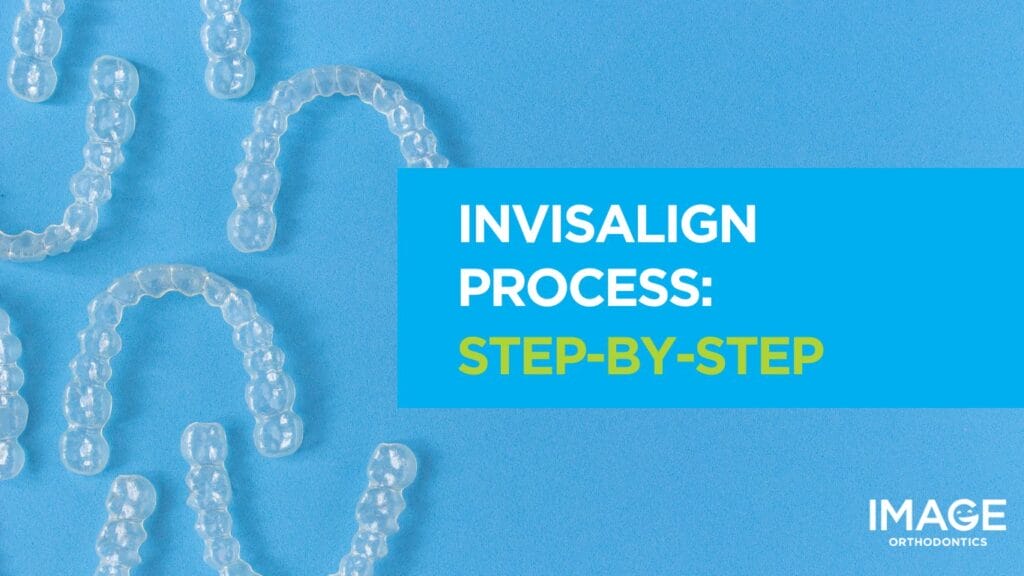 Clear Invisalign aligners arranged on a blue background.