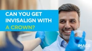 Header - Close-up of a man in a dental chair as a clinician holds an Invisalign aligner