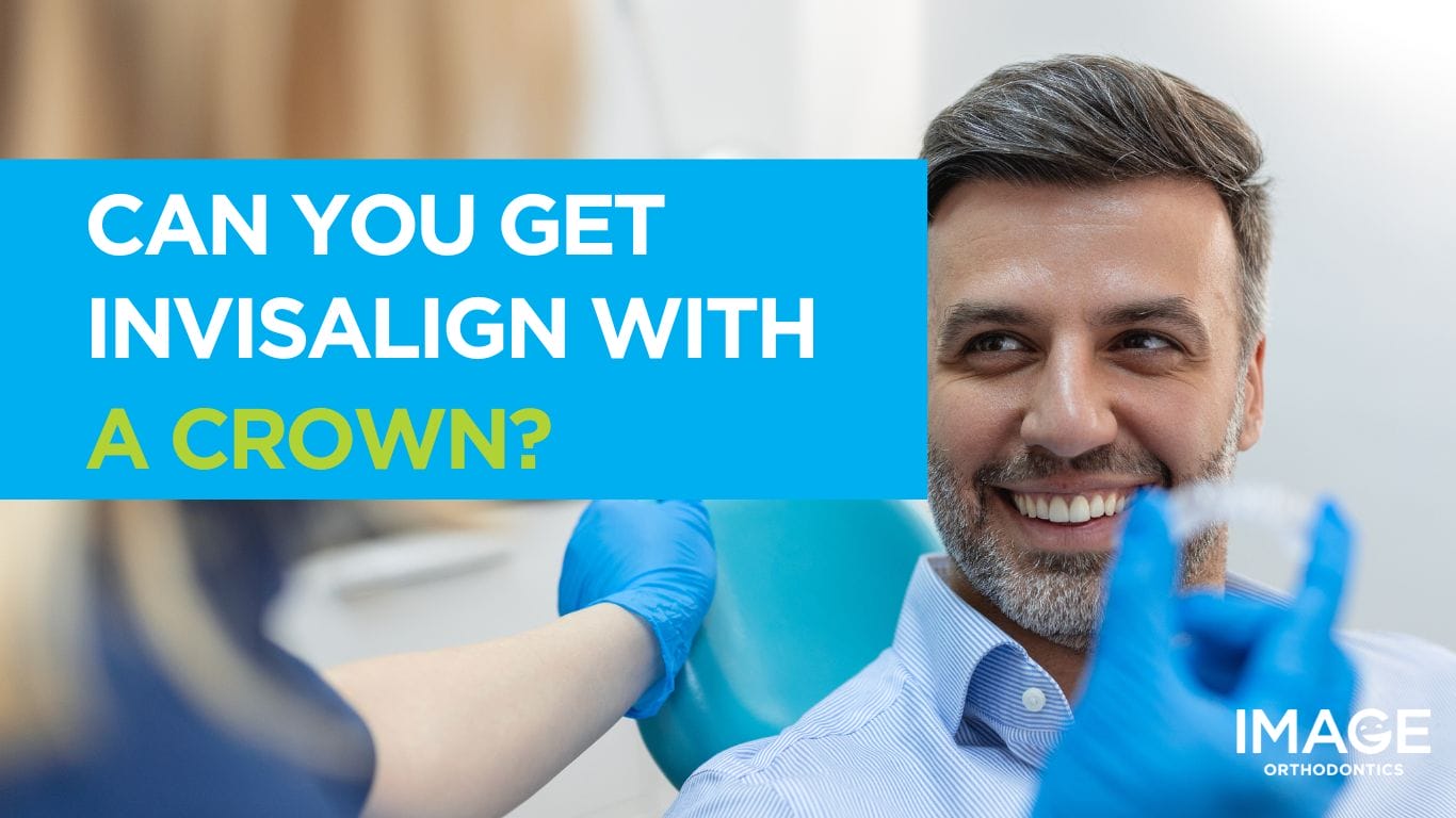 Header - Close-up of a man in a dental chair as a clinician holds an Invisalign aligner
